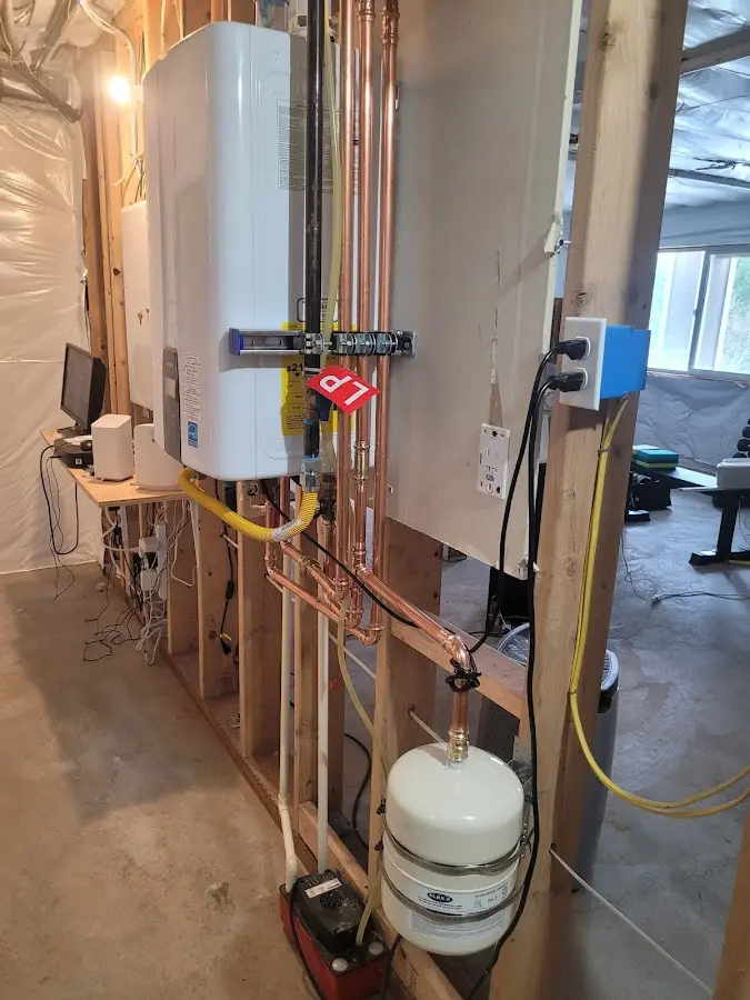 Licensed plumber repairing a kitchen sink in St. Michael